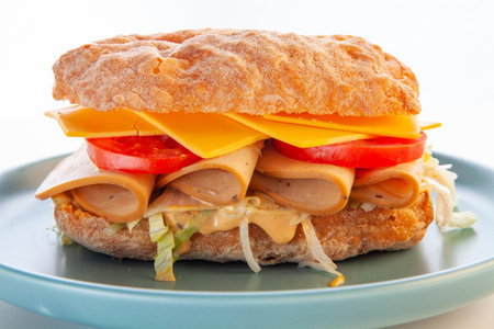 Bologna meat ciabatta sandwich on a blue plate.の写真素材