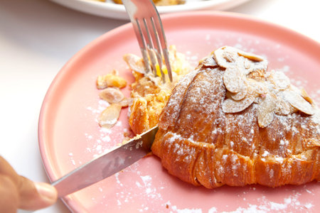 Brioche almond croissant eating at a fancy cafe.の写真素材