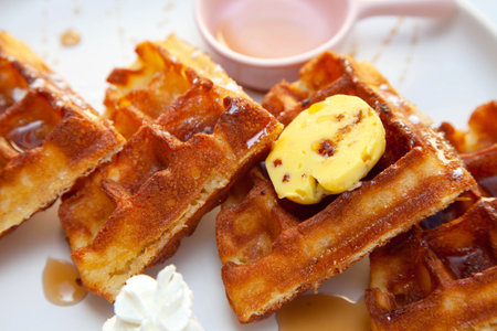 Chocolate waffle with dressing of chocolate sauce and strawberry gelato on the side.の写真素材