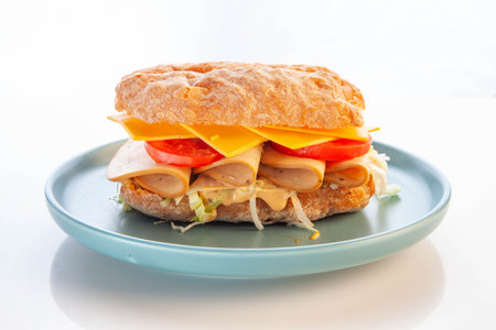 Bologna meat ciabatta sandwich served in a blue plate.の写真素材