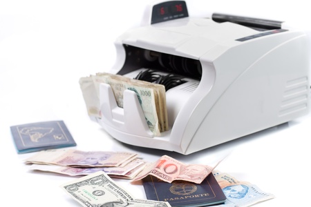 An electronic money counter processing bills and passportの写真素材