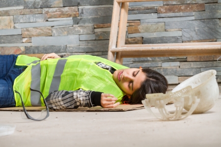 Woman in accident at workplaceの写真素材