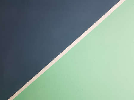 Painted wall in two colors dark blue and mint with a white stripe in the middleの写真素材