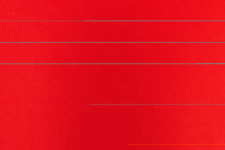 Red background with a thick massive silver chainの写真素材