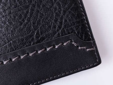Ð¡lose-up of black grainy and smooth leather with decorative gray stitchingの写真素材