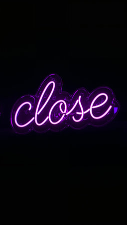 Neon sign in the shape of the word close on a black backgroundの素材