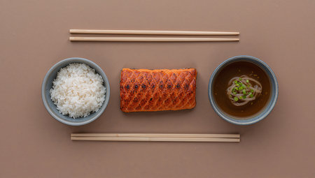 Rice, miso soup and salmon in bowl on brown backgroundの素材