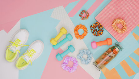 Flat lay composition with sport equipment on pink and blue background.の素材