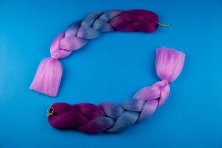 Colored braids on a blue background, romantically braided.の写真素材