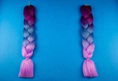 Colored braids on a blue background, romantically braided.の写真素材