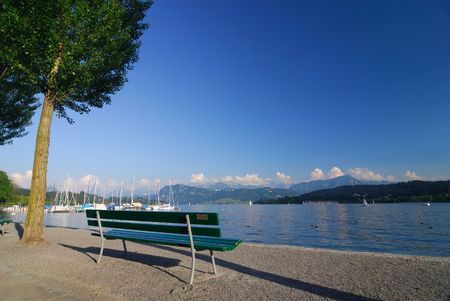 A bench in the Swiss Alps by Lake Luzernの写真素材