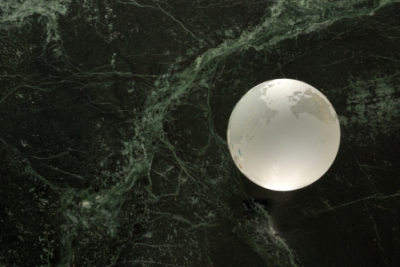 A glass earth orb on a 'universe' backgroundの写真素材