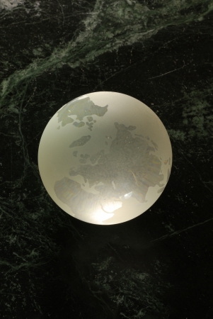 A glass earth orb on a 'universe' backgroundの写真素材