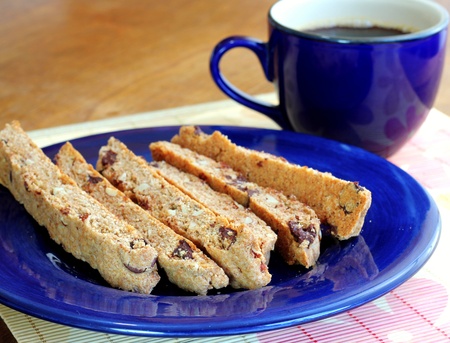 Homemade whole wheat biscotti with chocolate chips on a bright blue plateの写真素材