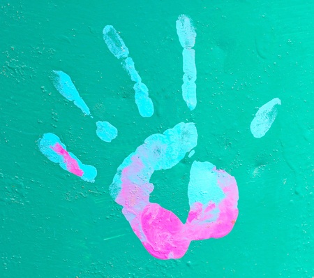 Colorful handprint: A paint handprint on a green wallの写真素材