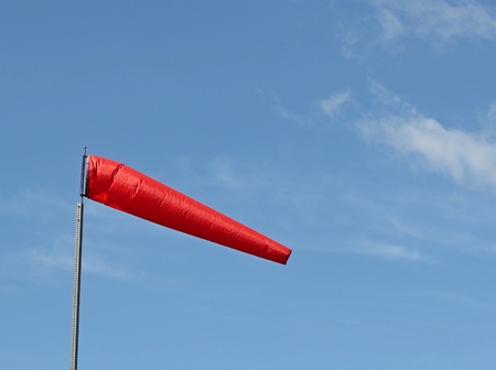 Bright red windsock blowing in the breezeの写真素材