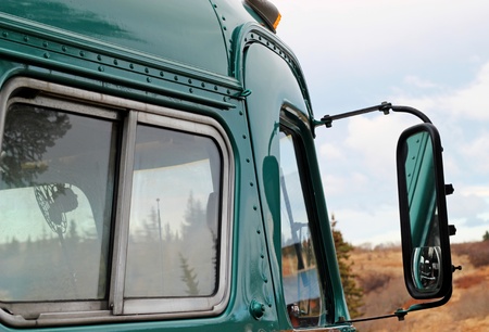 Crop of a 1947 antique bus with rural scenery in the background.のeditorial素材