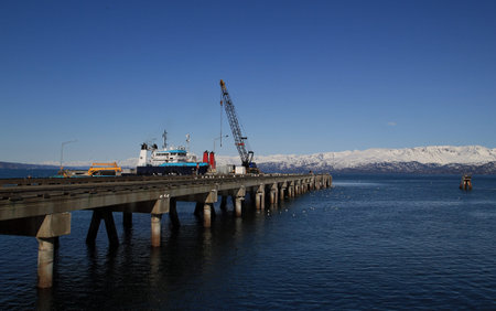 Commercial deep dock shipping pier in Homer Alaska on a sunny day.