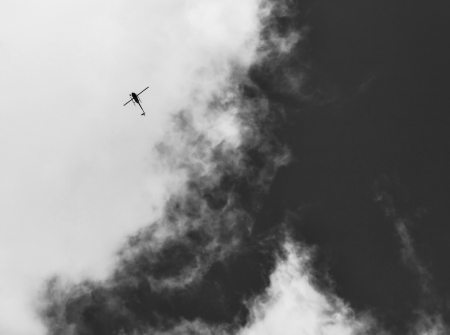 Small helicopter straight up in the clouds on a flight seeing trip.の写真素材