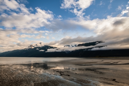 Wispy clouds over the Chilkat mountains near Haines Alaska in evening light.の写真素材