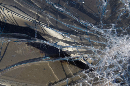 Shattered windshield glass, close-up.