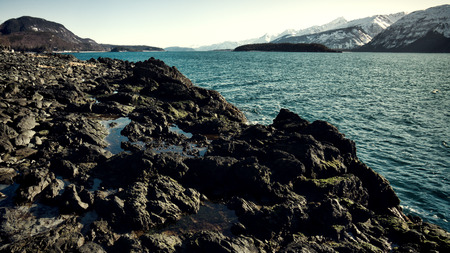 Rocky beach in Southeast Alaska on the Chilkat Inlet on a sunny winter day.の写真素材