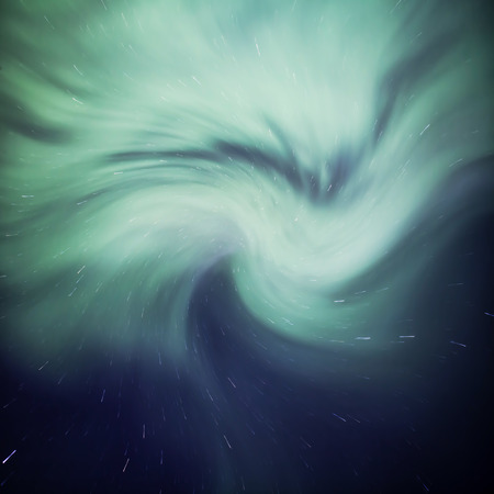 Northern lights in a night sky with a swirl added.の写真素材