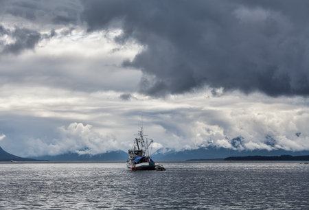 Old fishing boat in Southeast Alaska with stormy skies.