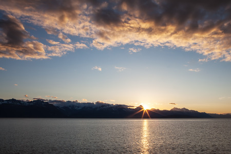 Sunburst at sunset at Echo Cove in Southeast Alaska.の写真素材