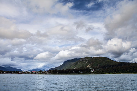 Skagway with summer clouds as seen from a boatの写真素材