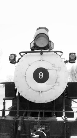 Old vintage steam engine on tracks in black and white.の写真素材