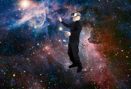 Man with VR Virtual Reality experiencing the wonders of space looking at a star.の写真素材