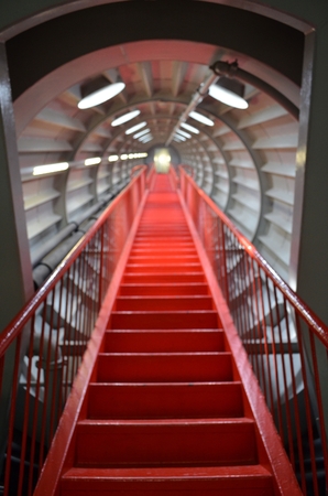 Red stairs appearing to ascend to infinityの写真素材