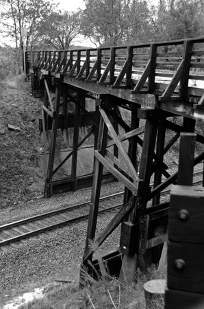 Old wooden train bridge with tracks belowの写真素材
