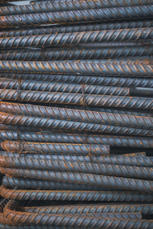 Deformed steel (Concrete reinforcement), with building under construction background, close-up steel...