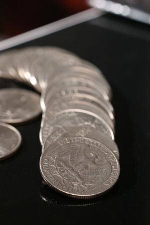 dimes and euro coins ower blackの写真素材