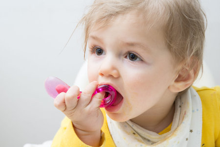 One very  cute  eleven  mounts old baby eatingの写真素材