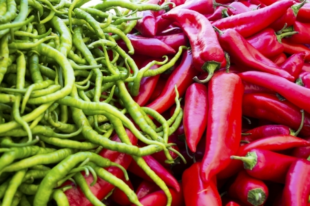 Heap of ripe red and green peppersの写真素材
