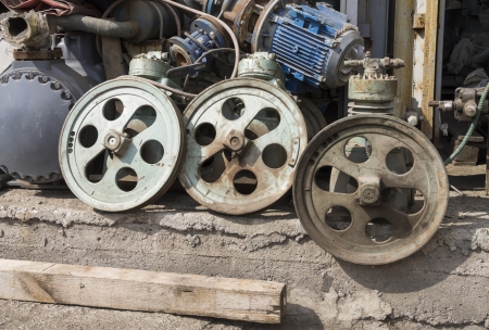 rusty scrap metal sheave, pulley parts in junkyardの写真素材