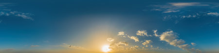 Panorama of blue sky at sunset with cirrus clouds in a seamless spherical conformal format. Full...