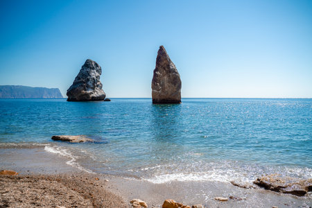Two rocks stick out of the water in the middle of the turquoise sea. Scenic ocean views. High quality photo. Like in Icelandの写真素材