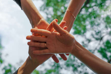 Team stacks hands in a workshop for teambuilding and teambuildingの写真素材