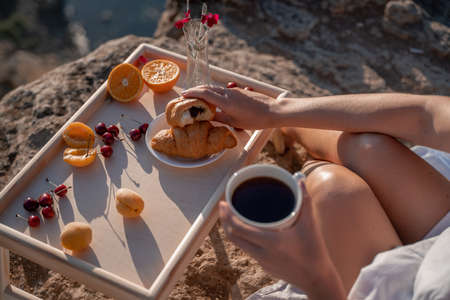 Mediterranean breakfast, cup of coffee and fresh bread on a table with beautiful sea view at the backgroundの写真素材