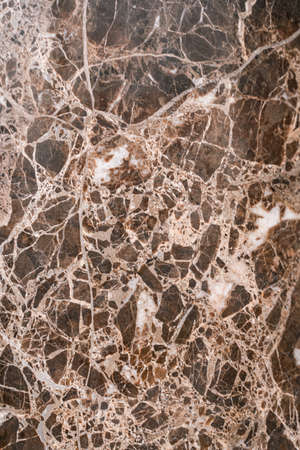 Luxurious dark brown marble with light streaks. The polished quartz stone background is naturally striped with a unique pattern, dark concentric stripesの写真素材
