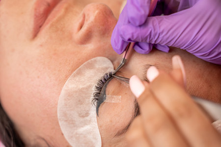 Eyelash extension procedure. Woman eye with long eyelashes. lashes, close up, macro, selective...