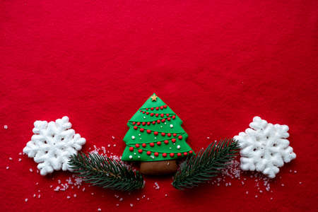 Christmas decorations layout or flatlay with fir branches and cones on red background.Eco natural frame. winter, new year Holidays concept as top view, copyspace. greeting card templateの写真素材