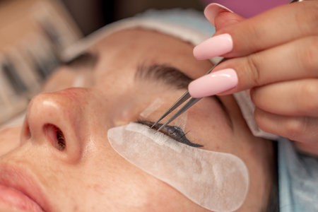 Eyelash extension procedure. Woman eye with long eyelashes. lashes, close up, macro, selective...