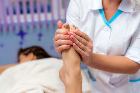 Facial massage. A woman is given a massage in a beauty salon. Close-up.の写真素材