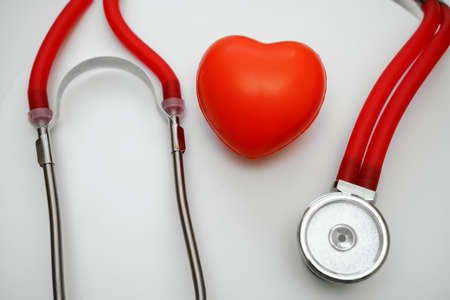 Stethoscope and red heart on white background, heart health, health insurance conceptの写真素材