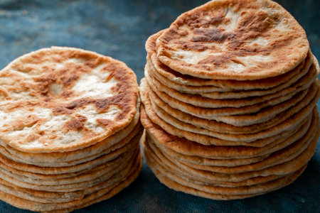 Flatbread lavash, chapati, naan, heap of tortilla on a blue background Homemade flatbread stacked.の写真素材